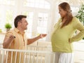 Laughing parents expecting baby