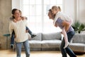 Laughing parents giving children piggyback ride playing together Royalty Free Stock Photo