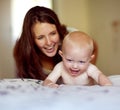 Laughing, playing and a mother with a baby on the bed for bonding, love and care in the morning. Wake up, smile and a Royalty Free Stock Photo