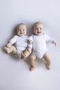 Laughing Plump Twin Babies in White