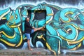 Laughing pregnant girl standing in door with abstract street art