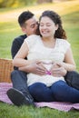 Laughing Pregnant Hispanic Couple Making Heart Shape with Hands on Belly Royalty Free Stock Photo