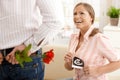 Laughing pregnant woman getting flowers Royalty Free Stock Photo