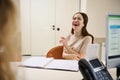 Laughing pretty woman at reception desk in modern office building Royalty Free Stock Photo