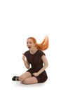 Laughing redhead woman flicking her hair