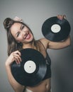 Laughing retro pin up girl holding vinyl records Royalty Free Stock Photo