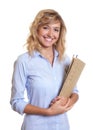 Laughing secretary with curly blond hair and file Royalty Free Stock Photo