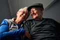 Laughing Senior Couple Sitting On Sofa At Home Watching Television Together Royalty Free Stock Photo