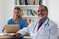 Laughing senior doctor with nurse Royalty Free Stock Photo