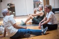 Laughing seniors resting on floor after dancing Royalty Free Stock Photo