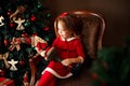 Laughing small girl with decorative Santa Royalty Free Stock Photo