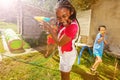 Girl with group of kids play water pistol fight Royalty Free Stock Photo