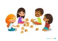 Laughing and smiling kids sit on floor in circle, play with toy cubes talk. Royalty Free Stock Photo