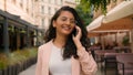 Laughing smiling woman Indian Arabian ethnic happy female girl businesswoman student talking mobile phone call telephone Royalty Free Stock Photo