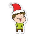 laughing sticker cartoon of a man wearing santa hat