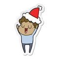 laughing sticker cartoon of a man wearing santa hat