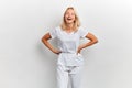 Laughing stylish beautiful woman with hands on hips posing in studio Royalty Free Stock Photo