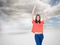 Laughing teenage wearing casual clothes while raising her arms