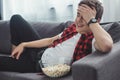 laughing teenager with popcorn watching comedy movie