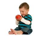 Laughing toddler holds a red apple