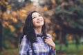 Laughing trendy girl in autumn park