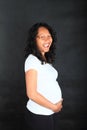 Laughing tropical pregnant woman in white t-shirt Royalty Free Stock Photo