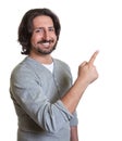 Laughing turkish guy pointing sideways Royalty Free Stock Photo