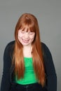 Laughing tween redhead girl with freckles