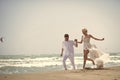 Laughing wedding couple on beach Royalty Free Stock Photo