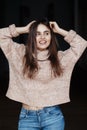 laughing white Caucasian brunette young beautiful girl woman model with long dark hair and brown eyes in turtleneck sweater Royalty Free Stock Photo