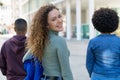 Laughing white female student with backpack and friends Royalty Free Stock Photo