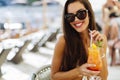 Laughing woman in bikini drinking cocktail Royalty Free Stock Photo