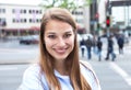 Laughing woman with blond hair in the city