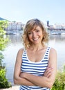 Laughing woman with crossed arms on a river Royalty Free Stock Photo