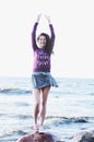 Laughing woman in dress and sweatshirt on the sea beach Royalty Free Stock Photo