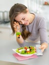 Laughing woman eating salad and watching tv Royalty Free Stock Photo