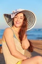 Laughing woman in hat on the beach Royalty Free Stock Photo