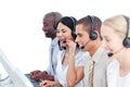 Laughing woman and her team in a call center