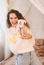 Laughing woman holding puppy jack russel terrier having fun in room close up. Happiness. Royalty Free Stock Photo