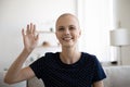 Laughing woman oncology patient calling home by video waving hand Royalty Free Stock Photo