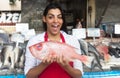 Laughing woman selling fresh fish on a latin fish market Royalty Free Stock Photo