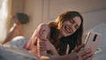 Laughing woman talking online conference closeup. Relaxed morning girl lying bed Royalty Free Stock Photo