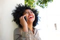 Laughing woman talking on smart phone outside Royalty Free Stock Photo