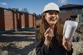 Laughing woman worker with layout talking by radio Royalty Free Stock Photo