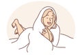 Laughing woman wrapped in blanket lies on bed not wanting to get up and go to work or college Royalty Free Stock Photo