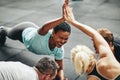 Laughing women high fiving while planking in a gym class Royalty Free Stock Photo