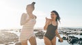 Laughing women, swimwear and running by sea, ocean or beach water on happy summer, comic holiday or bonding travel