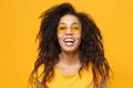Laughing young african american woman girl in casual t-shirt, eyeglasses posing isolated on yellow orange wall Royalty Free Stock Photo