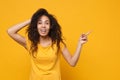 Laughing young african american woman girl in casual t-shirt posing isolated on yellow orange background. People Royalty Free Stock Photo