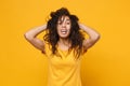 Laughing young african american woman girl in casual t-shirt posing isolated on yellow orange background in studio Royalty Free Stock Photo
